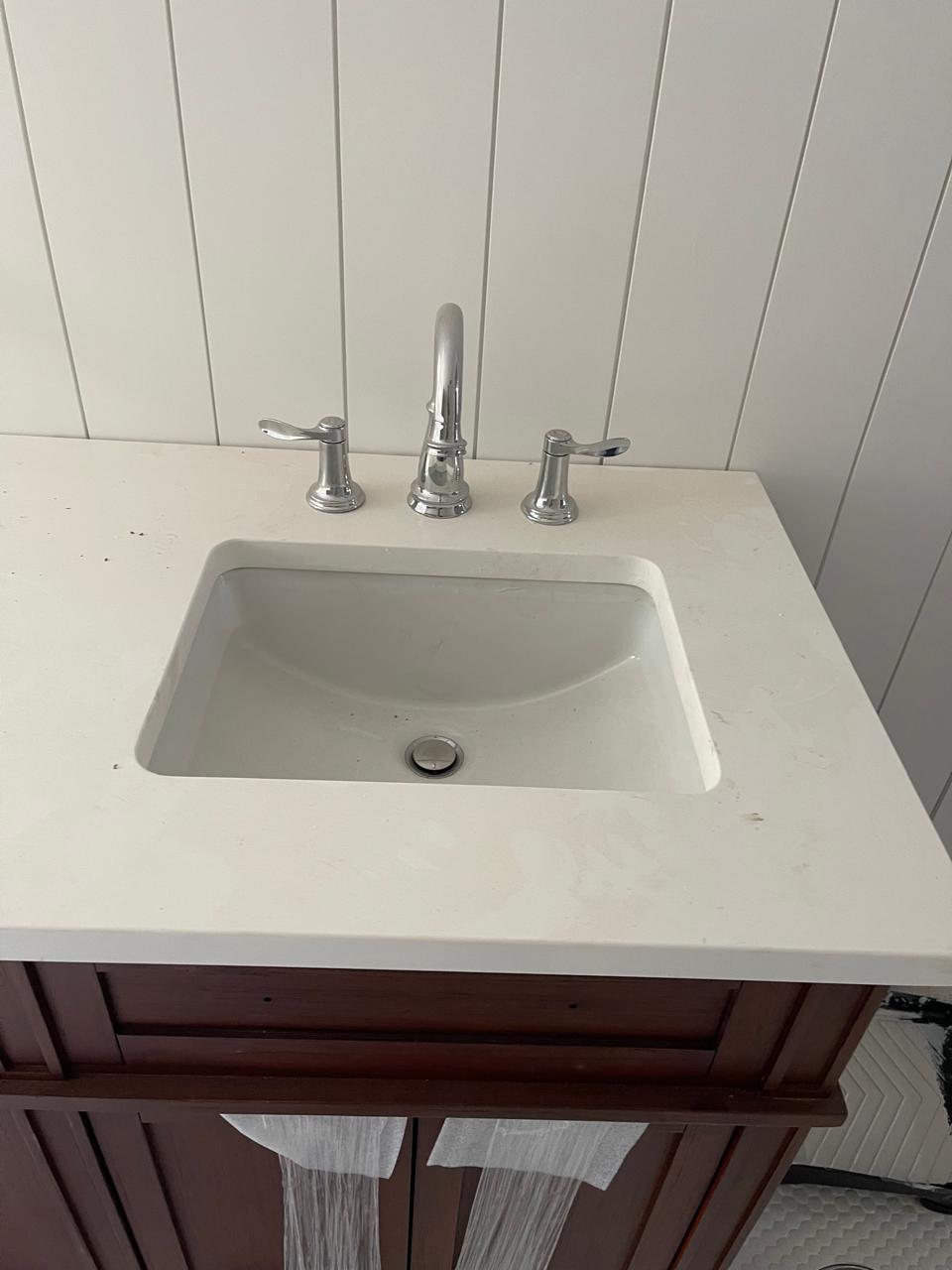 Faucet and drain finished installation in bathroom sink