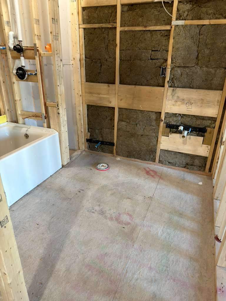 Complete bathroom plumbing installation including sink, shower, and toilet