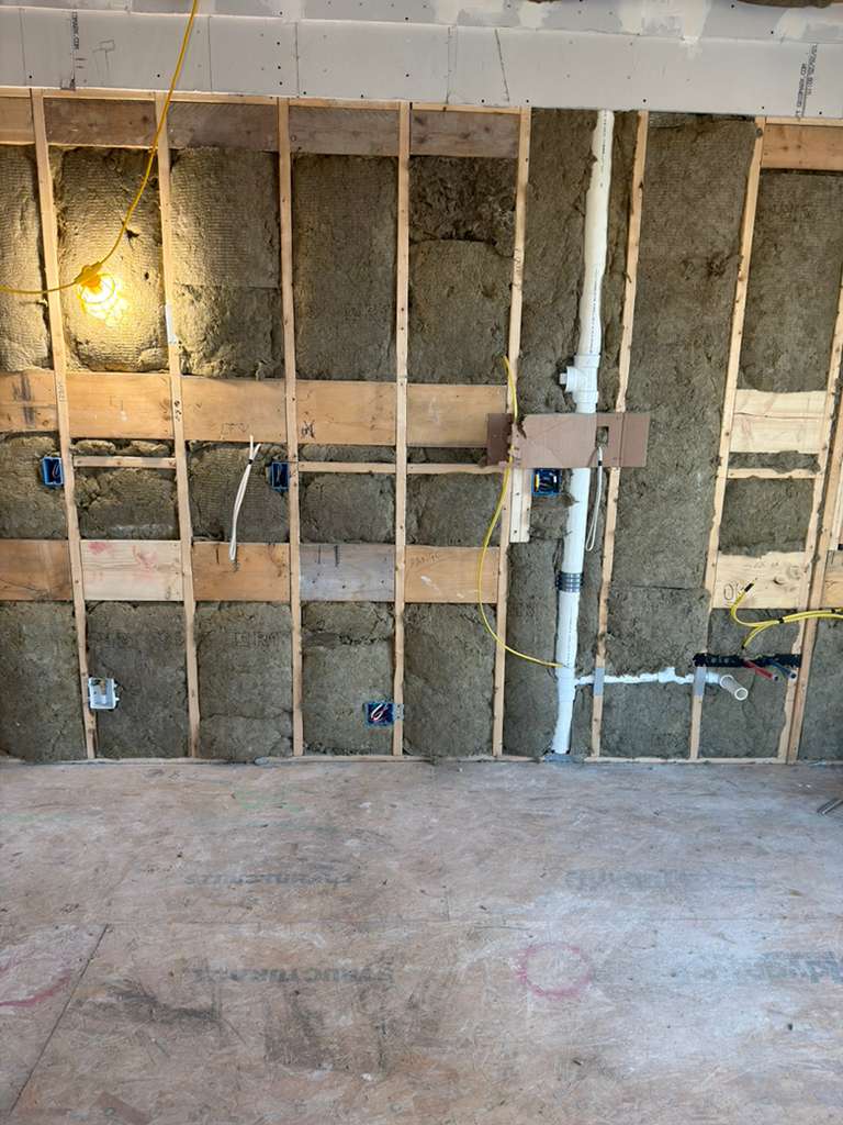 Under sink plumbing installation with ice maker connection in kitchen