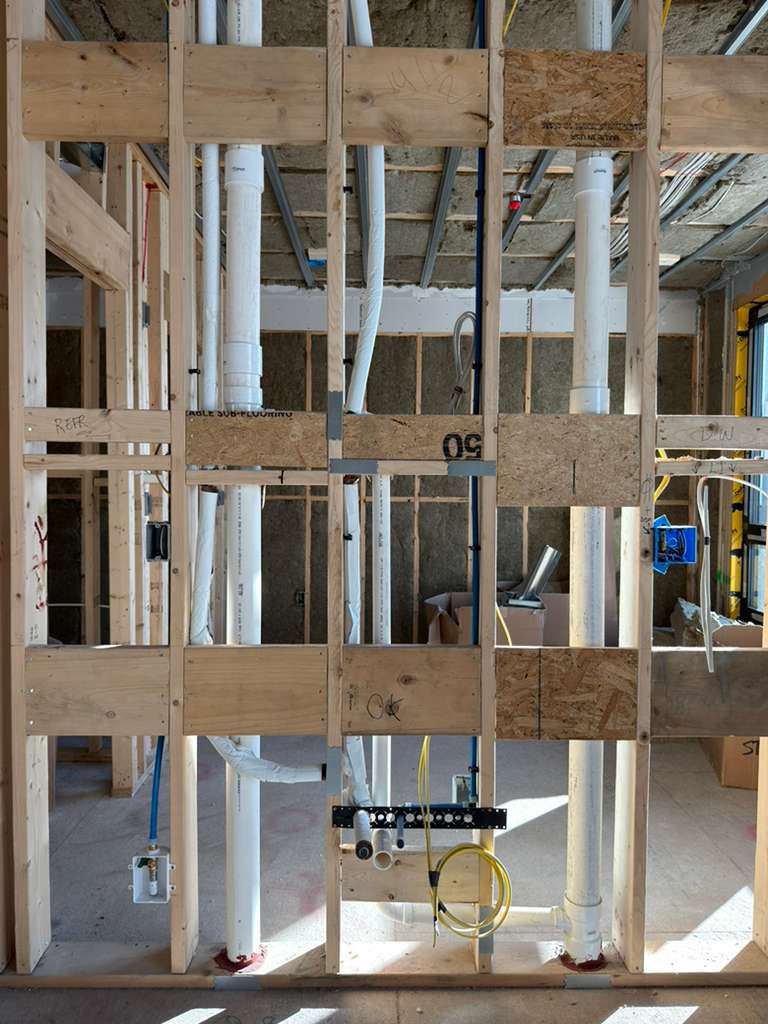 Kitchen sink and ice maker plumbing installation in residential kitchen, rough water piping service